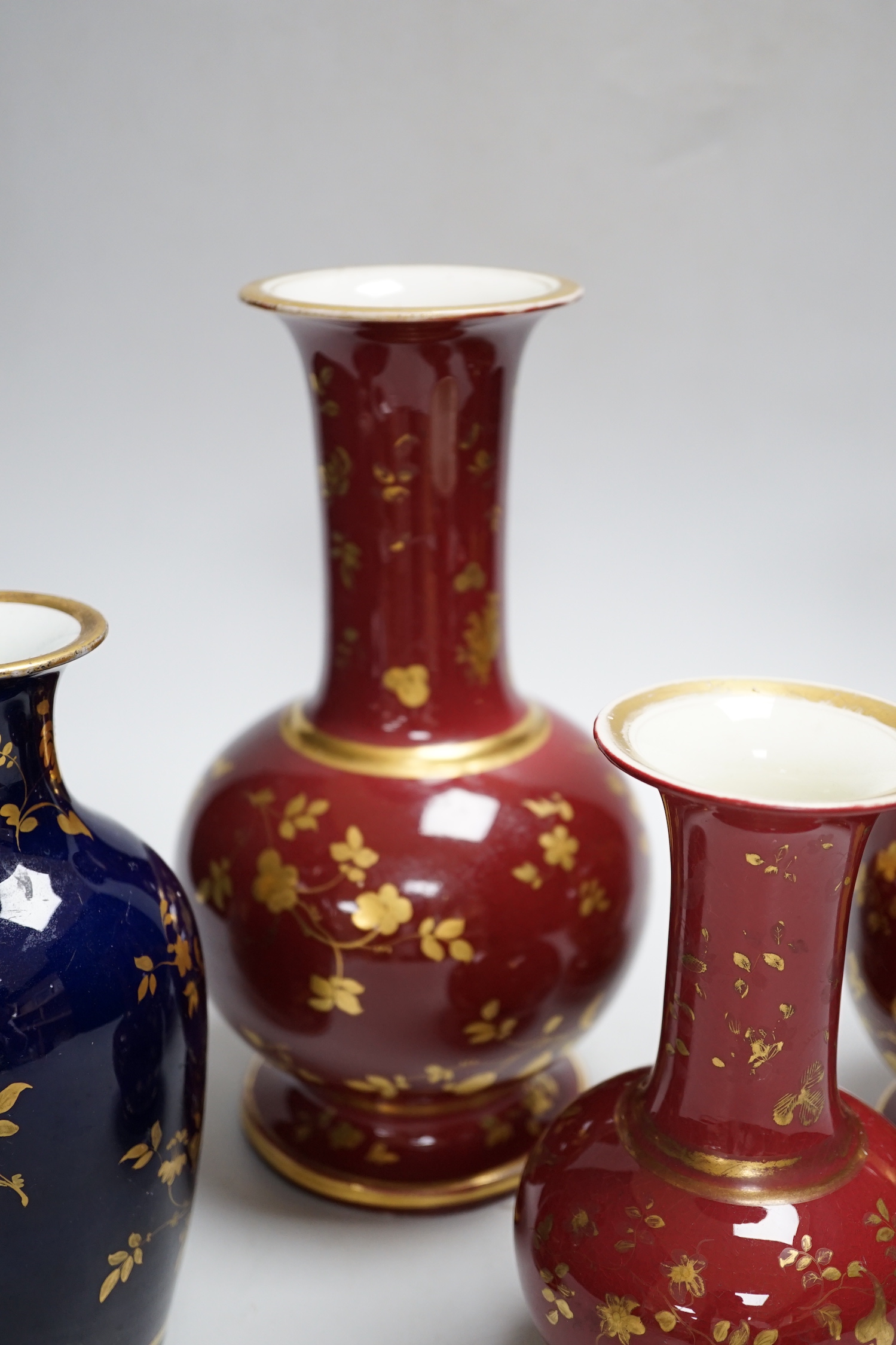 A pair of late 19th century French porcelain vases, and two others, tallest 25cm high